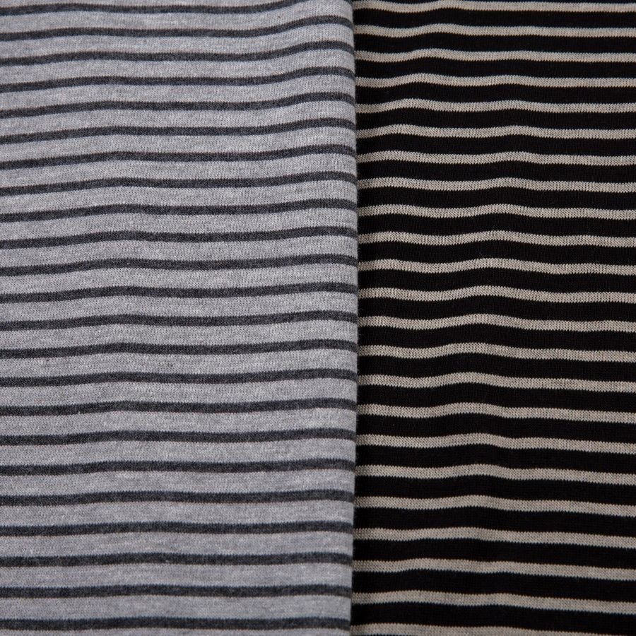 Two fabric swatches with striped patterns, one in gray and black stripes on a white background, and the other in black and white stripes on a gray background.