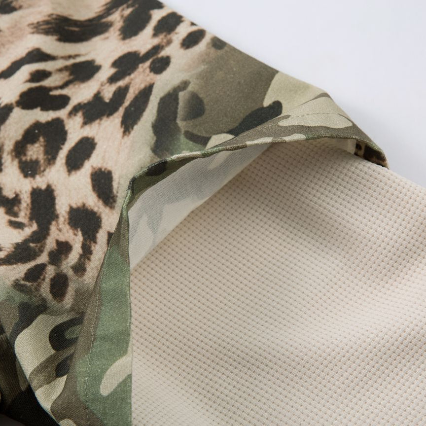 Close-up of fabric with camouflage and leopard print patterns on a white background