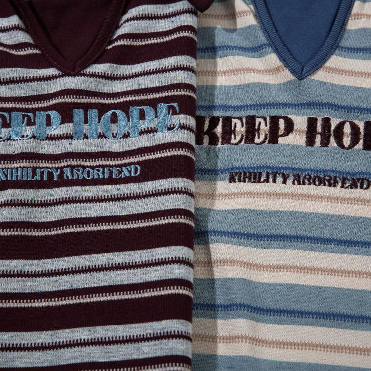 Two striped shirts with 'KEEP HOPE' text on a plain background