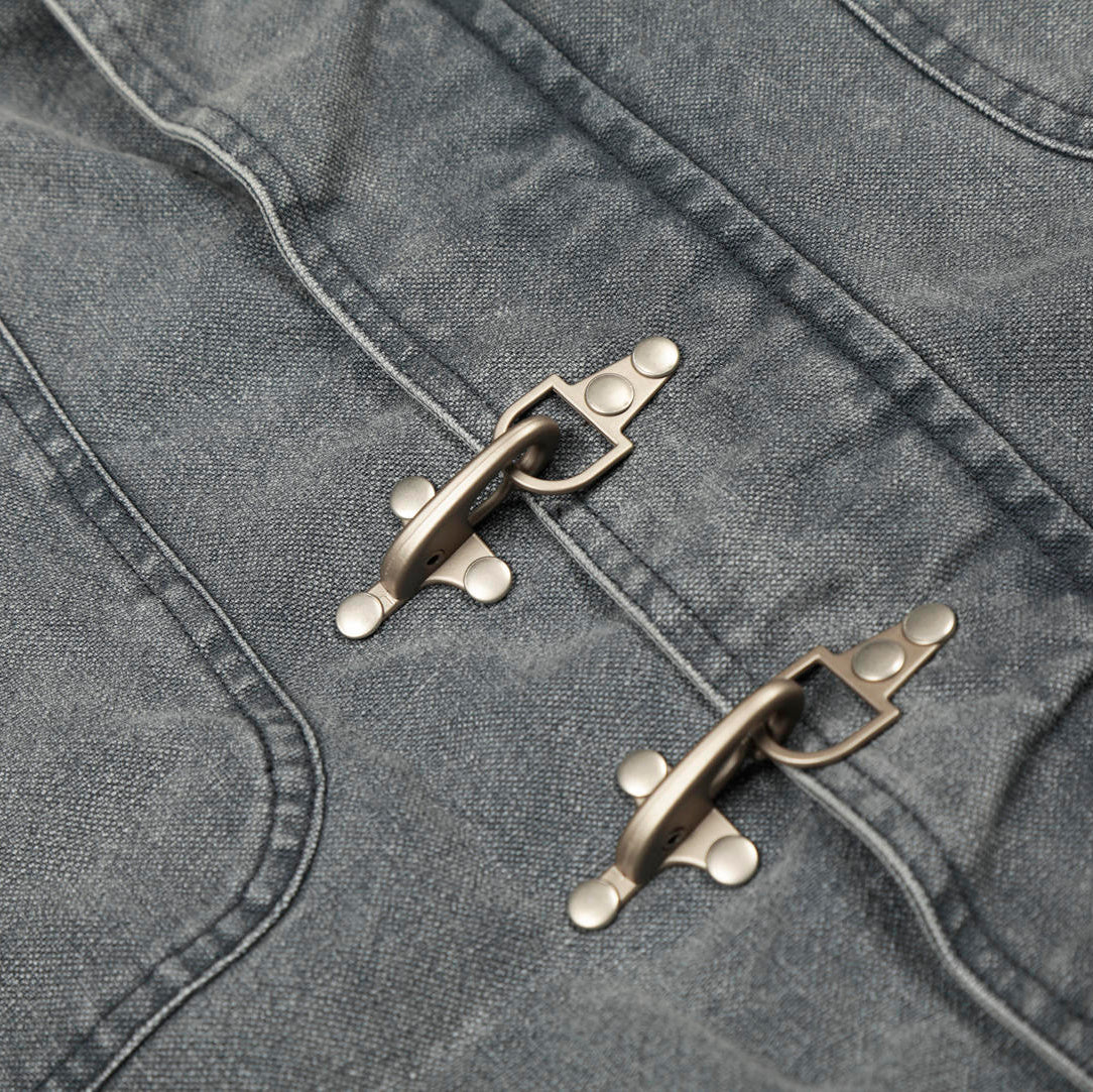 Close-up of a gray jacket with metal buttons