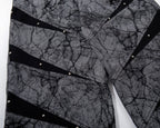 Close-up of a textured fabric with black geometric patterns on a white background