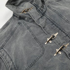 Close-up of a gray jacket with metal buttons on a light gray background