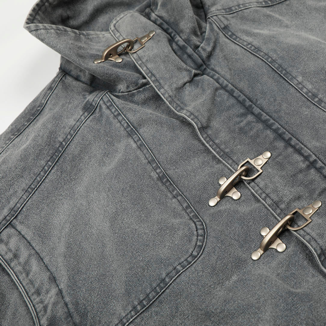 Close-up of a gray jacket with metal buttons on a light gray background