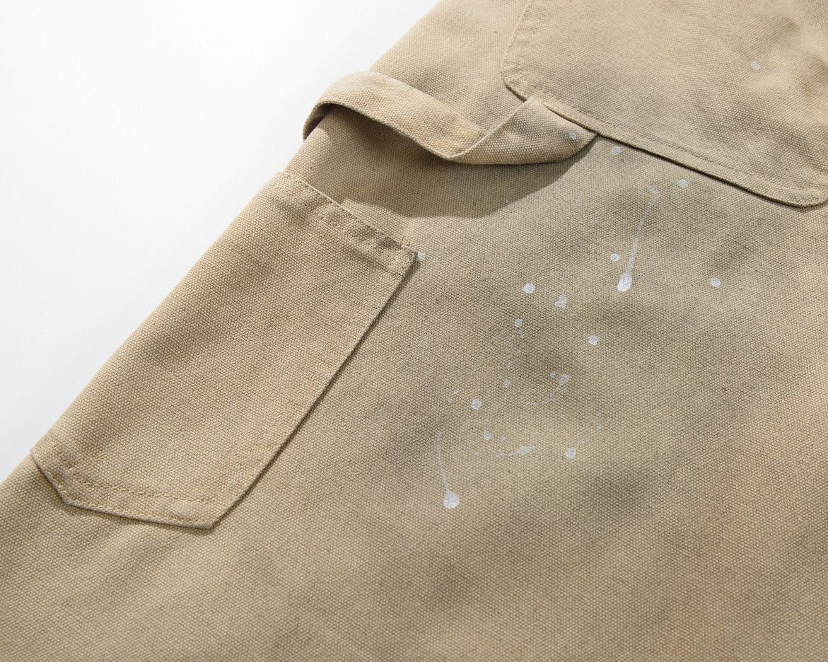 Close-up of a beige shirt with a pocket and visible stains on a white background