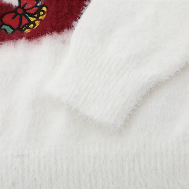 Close-up of a white fabric with a colorful embroidered design on a red background