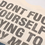 Textured fabric with printed text 'DON'T FUCK YOURSELF TRYING TO COPY ME' on a beige background.
