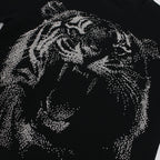 Black t-shirt with a tiger design made of small stones on a white background
