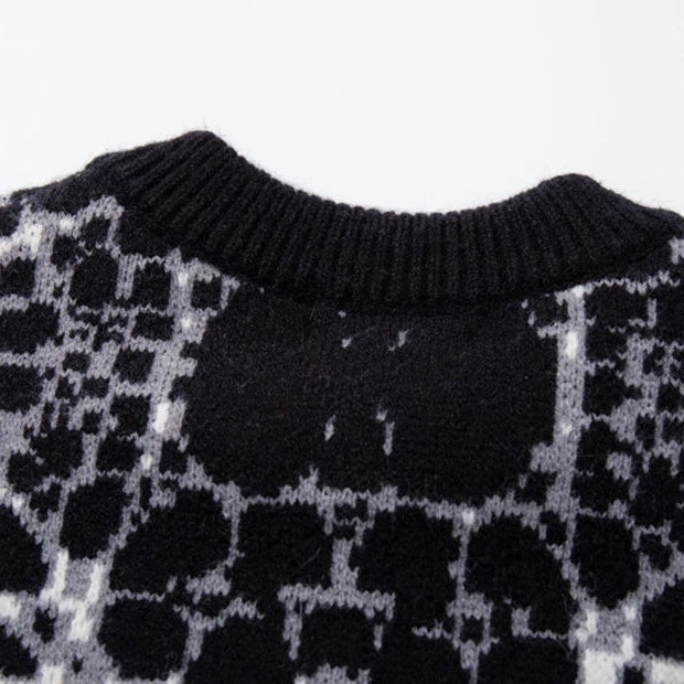 Close-up of a patterned sweater with black and white design on a white background