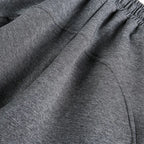 Close-up of gray sweatpants with an elastic waistband