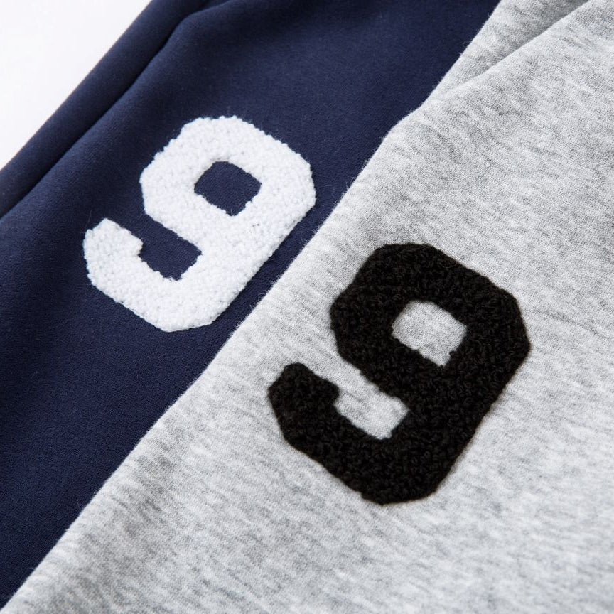 Two numbers '9' on a piece of clothing, one white and one black.