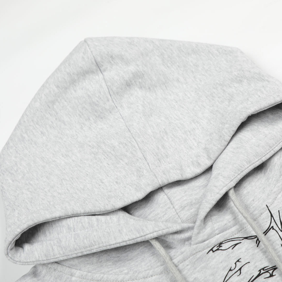 Gray hoodie with a graphic design on a light gray background