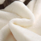 Close-up of soft, textured fabric in white and beige tones.