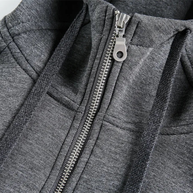 Close-up of a gray zip-up hoodie with a zipper detail.