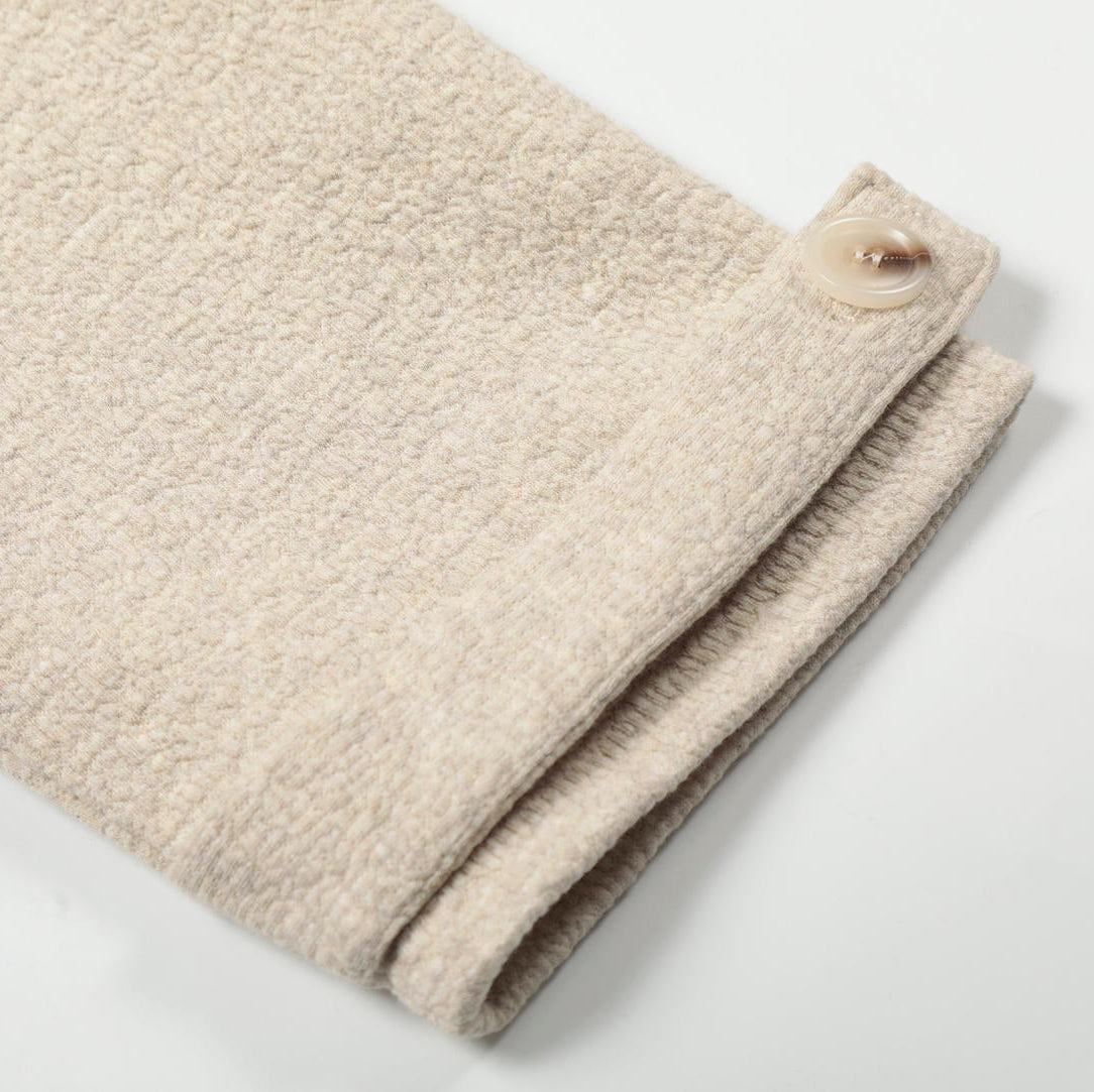 Folded beige fabric on a white background