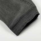 Folded gray denim shirt on a white background