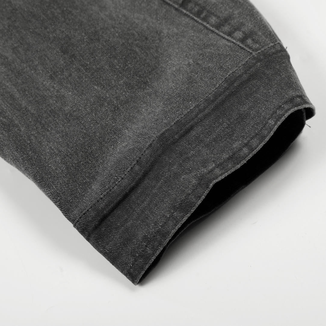 Folded gray denim shirt on a white background