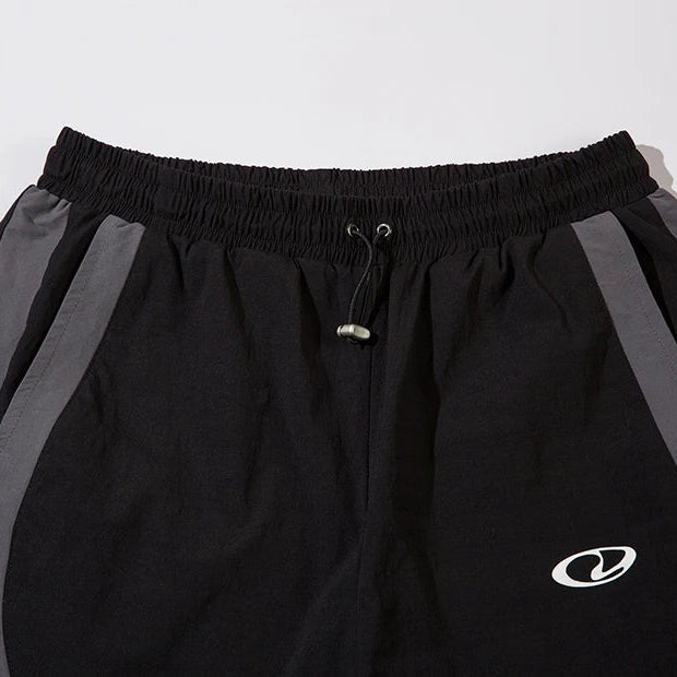Black shorts with a logo on a light gray background