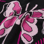 Close-up of a pink butterfly design on a black background