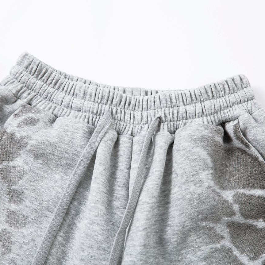 Gray sweatpants with a subtle pattern on a light gray background