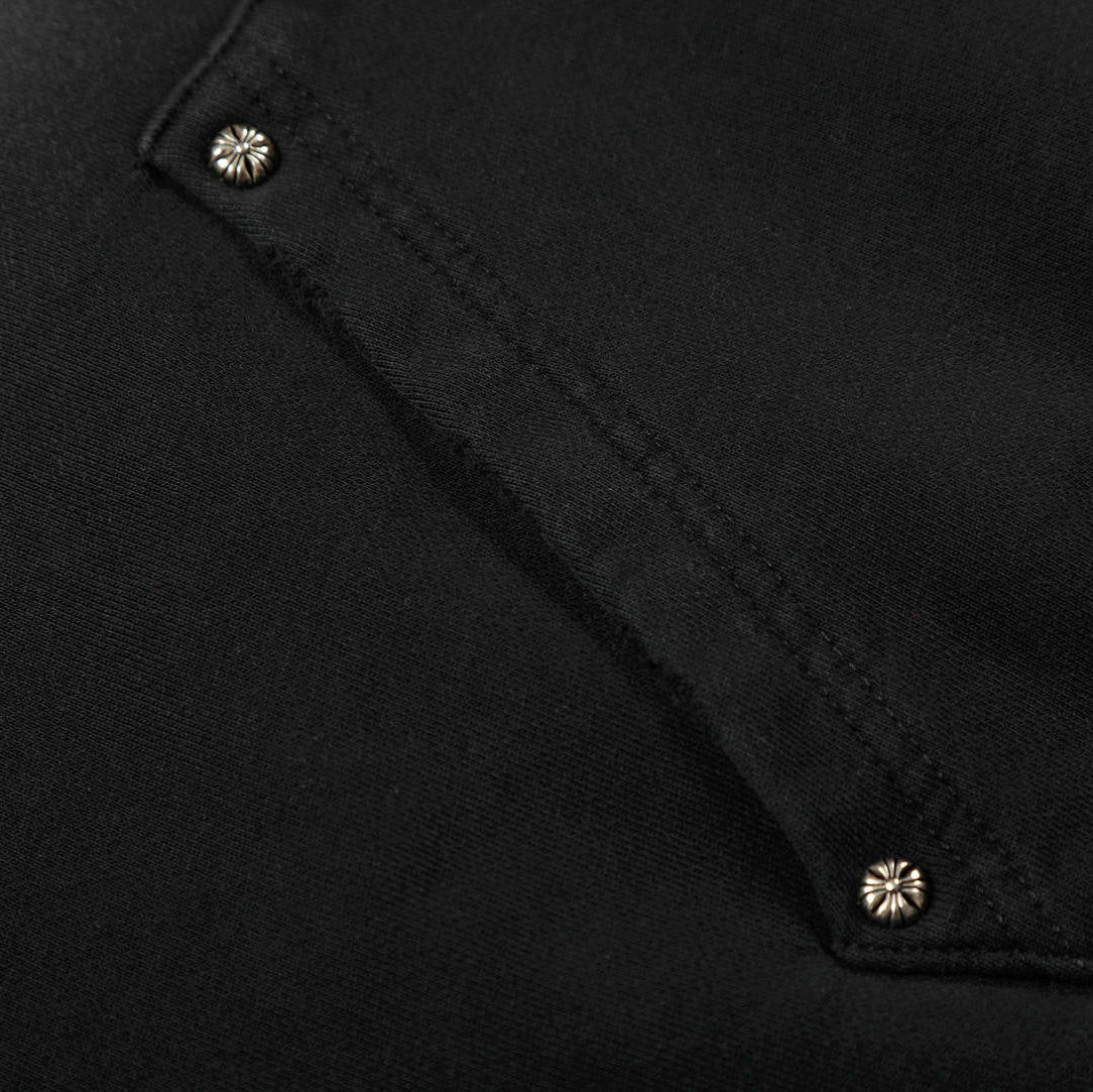 Close-up of a black fabric texture with button details