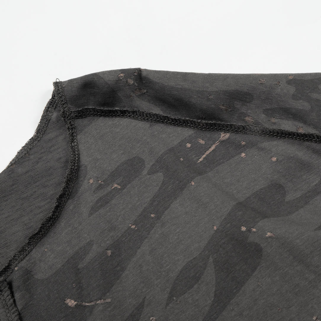 Black camouflage-patterned fabric with visible stitching on a white background