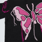 Black sweater with pink butterfly design on a white background
