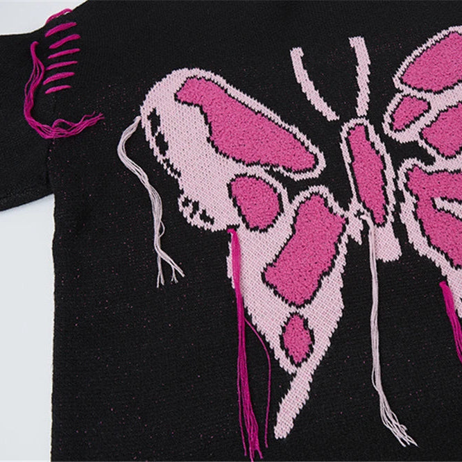 Black sweater with pink butterfly design on a white background