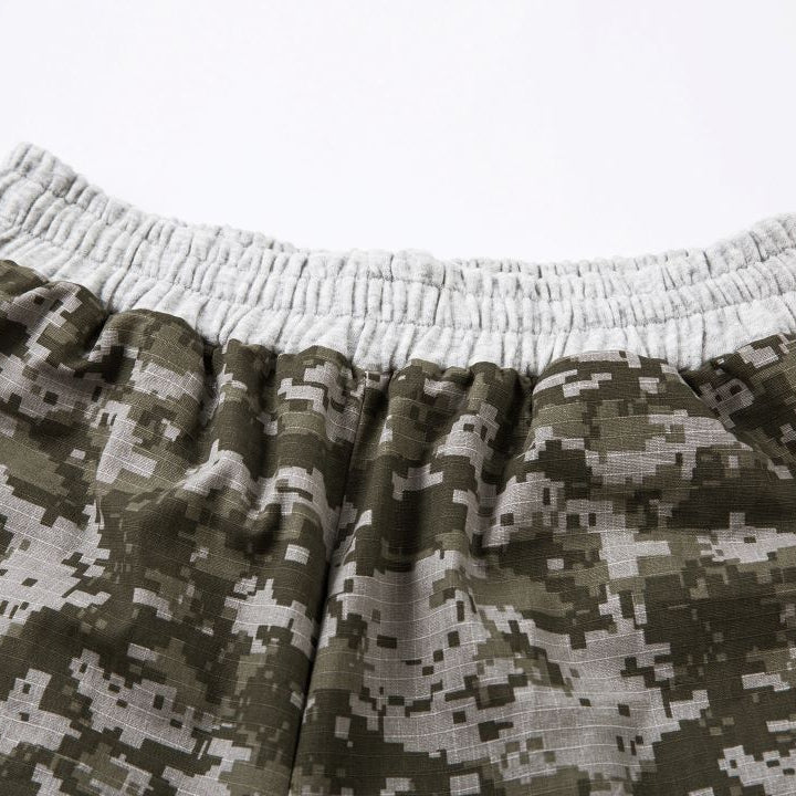 Digital camouflage shorts on a white background