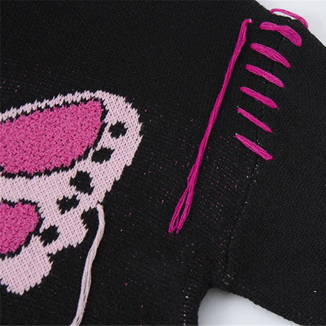 Black fabric with pink embroidered design on a white background
