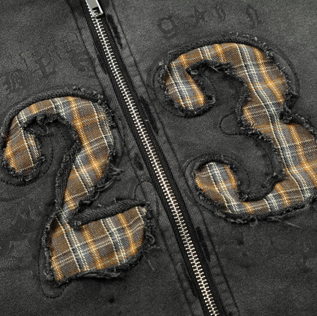 Plaid numbers '23' on a dark fabric background