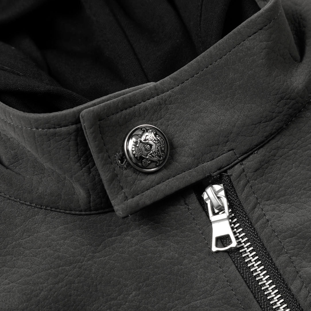 Close-up of a black jacket with a button and zipper detail