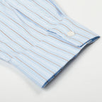 Close-up of a light blue striped shirt with a collar on a white background