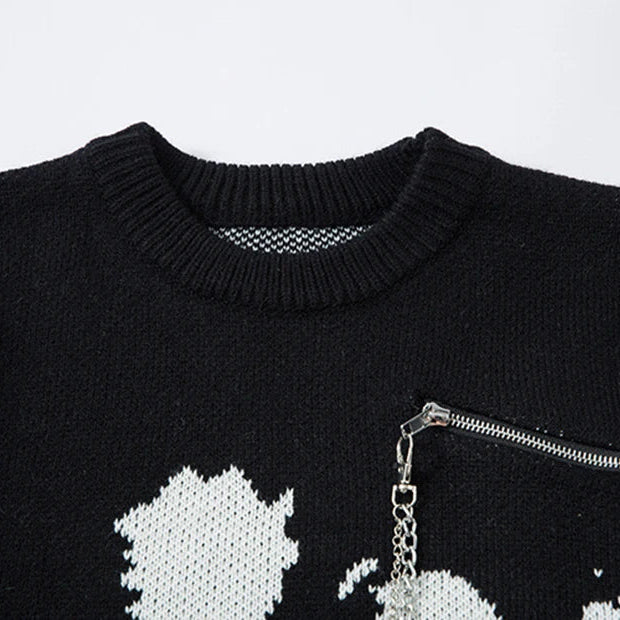 Black sweater with white star design and silver zipper on a light gray background