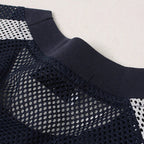 Navy blue athletic jacket with mesh design on a light gray background