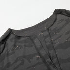 Black camouflage-patterned shirt with a brand logo on a white background