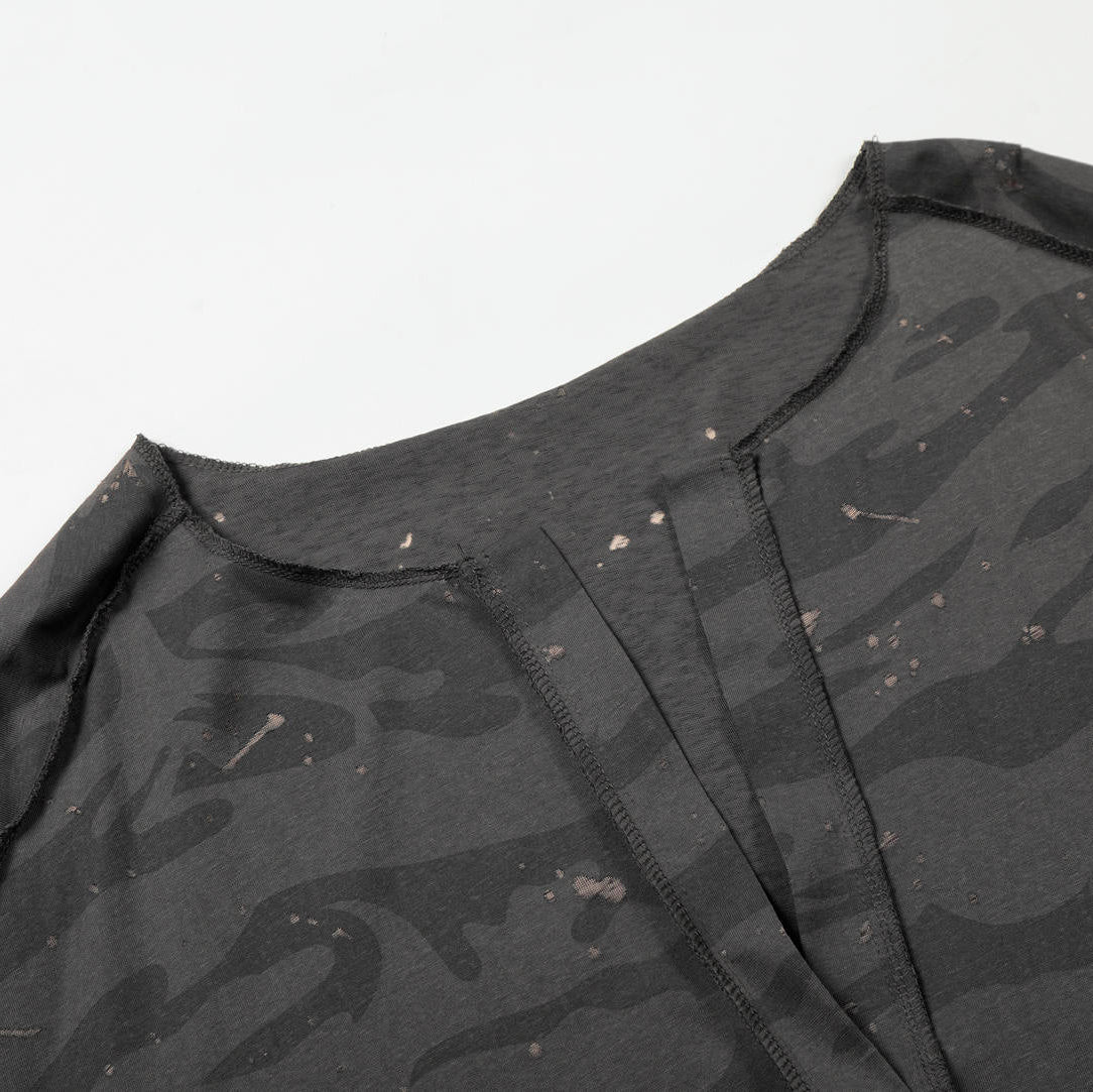 Black camouflage-patterned shirt with a brand logo on a white background