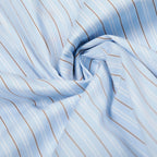 Close-up of light blue fabric with thin brown stripes.