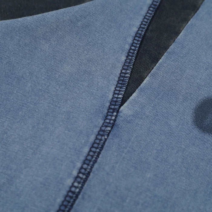 Close-up of a blue garment with a zipper and brand logo. h0neyebar streetwear
