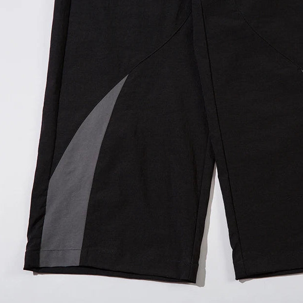 Black pants with gray panels on a white background