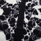 Close-up of a black and white patterned fabric with buttons.