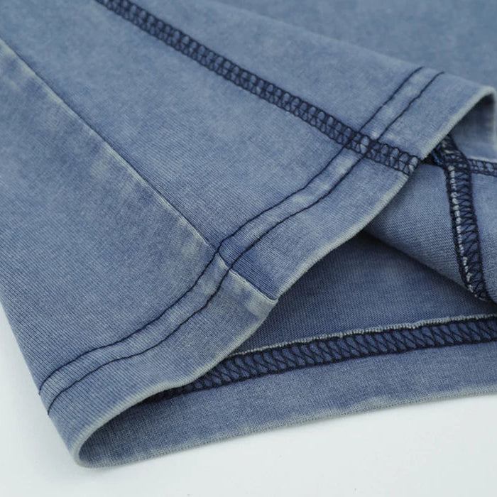 Close-up of a folded blue denim fabric on a white background