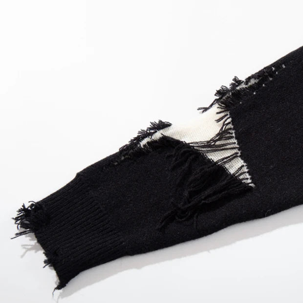 Black sweater sleeve with white distressed pattern on a white background