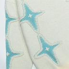 Textured fabric with star patterns in light blue and beige on a white background