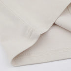 Close-up of beige fabric with a white background