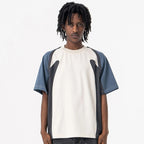 Person wearing a Velocity Panel t-shirt with a white and blue design on a plain background