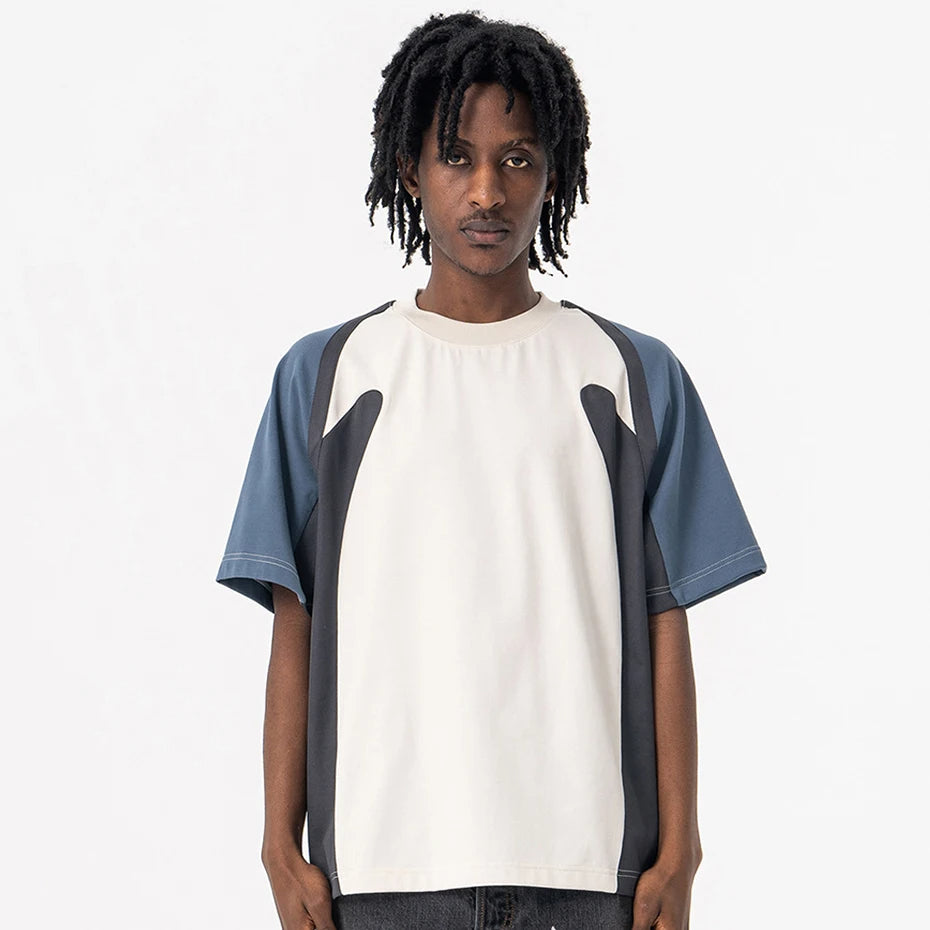 Person wearing a Velocity Panel t-shirt with a white and blue design on a plain background