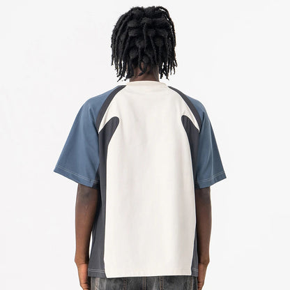 Person wearing a Velocity Panel t-shirt with a white and blue design on a plain background